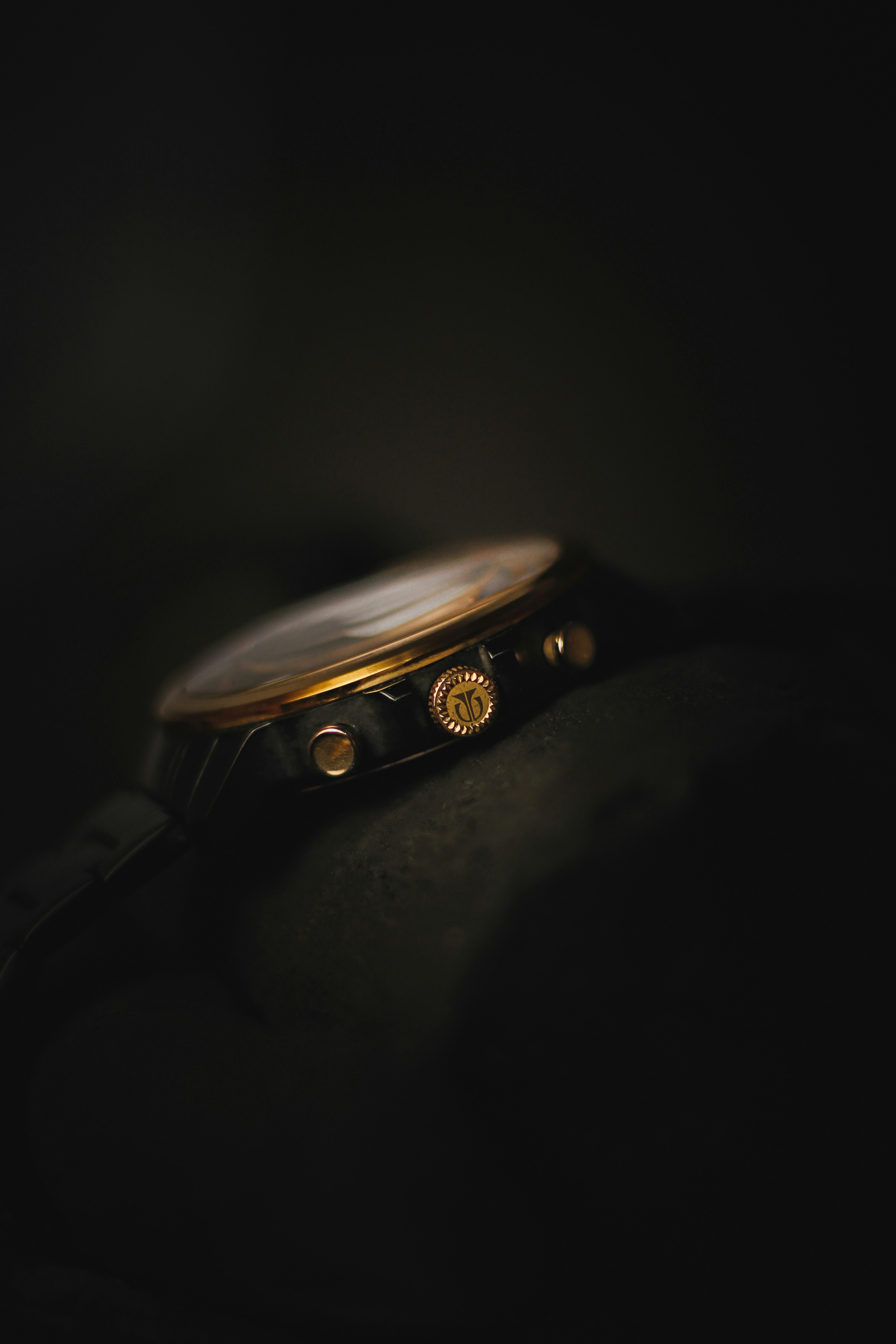 a close up of a watch on a black surface